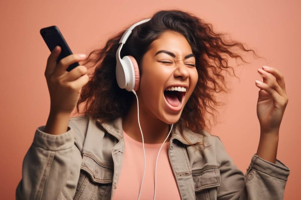 A young excited woman listening to an audiobook on her mobile phone